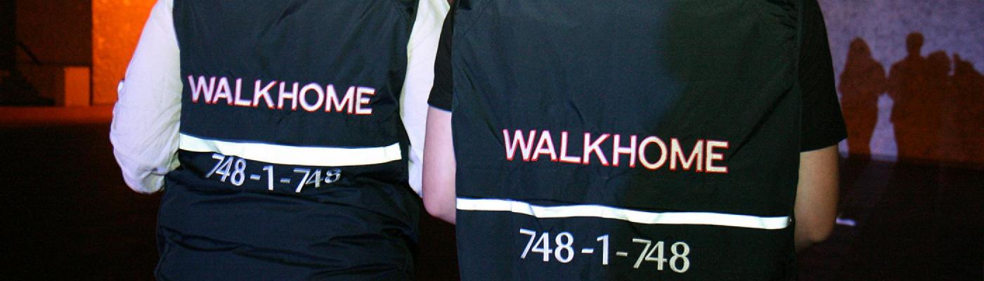 2 people wearing a vest that says walkhome at the back