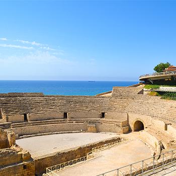 coliseum at noon beside the sea