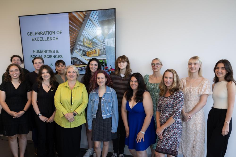 President Cathy Bruce standing with the award-winning students. 