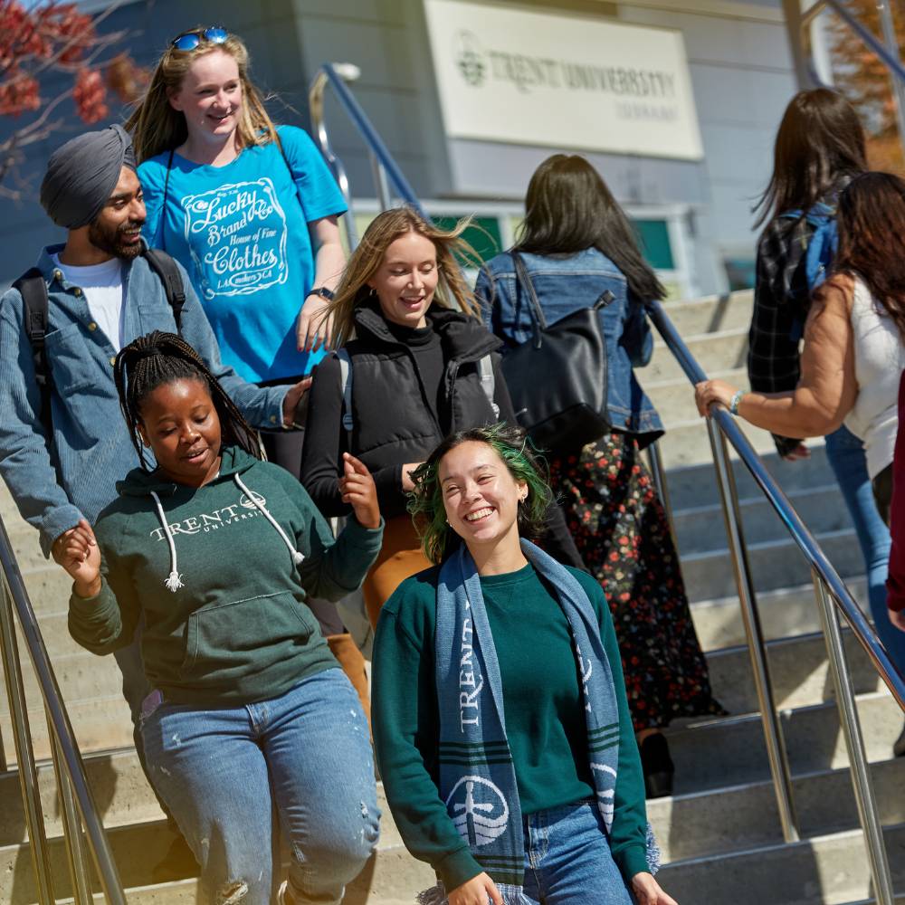 A group of people descending the outdoor stairway at Trent's Durham GTA campus.