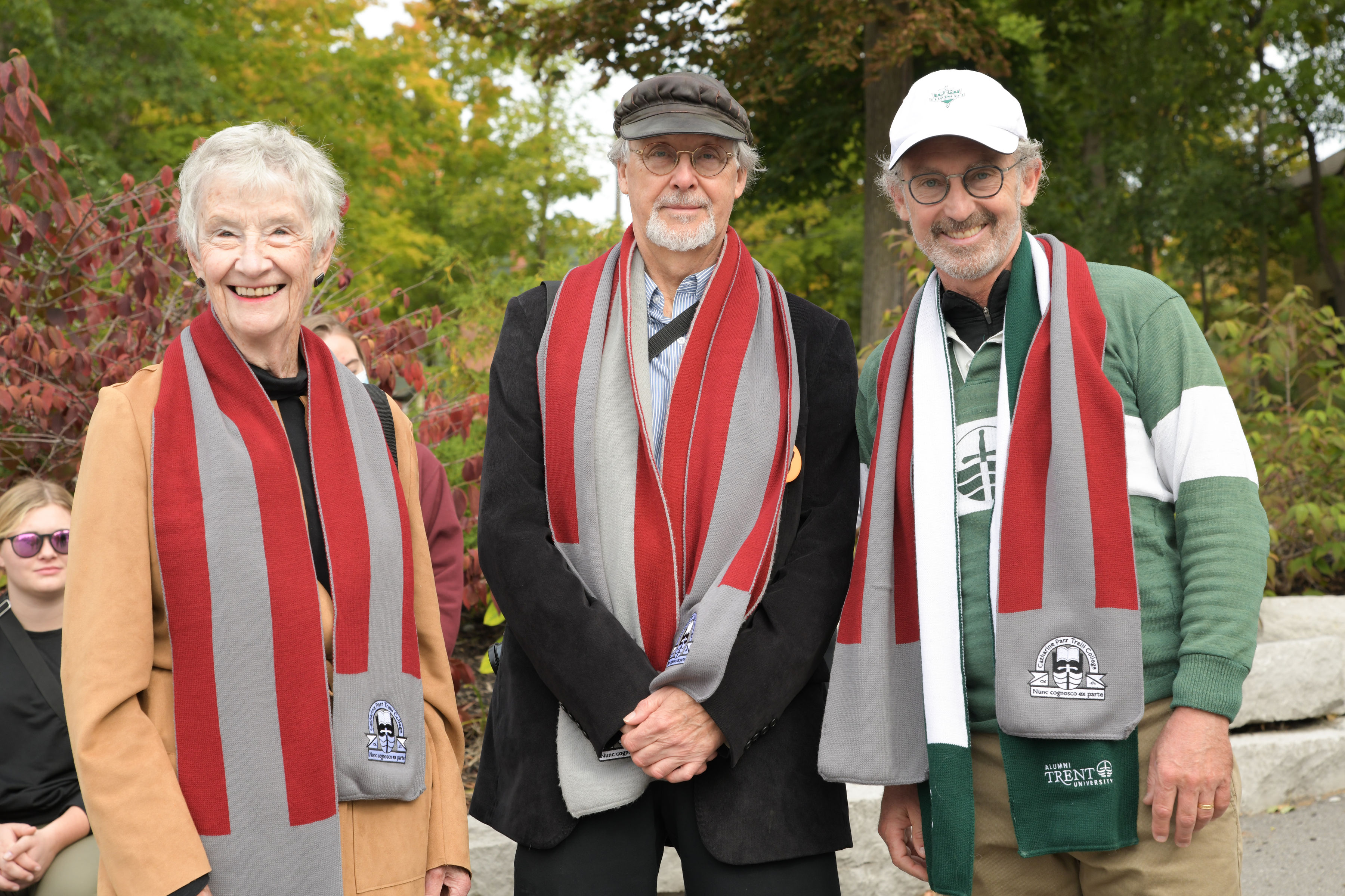 Three alumni wearing Traill scaves