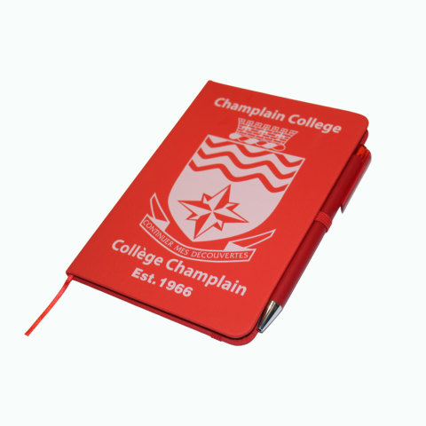 Red notebook with pen, champlain crest on the fron with text "Est. 1966"