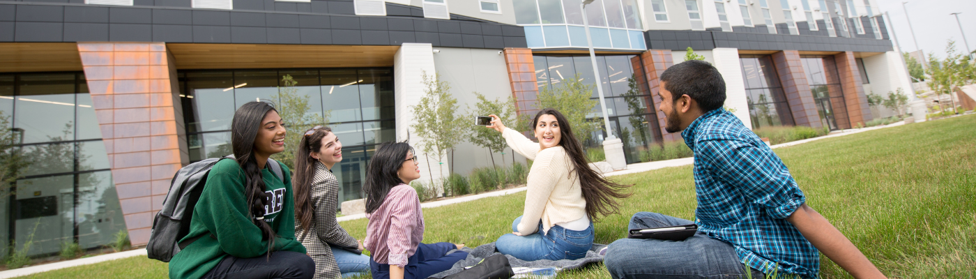 students sitting in grass