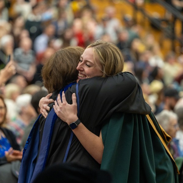 A graduating hugging their professor at Convocation.