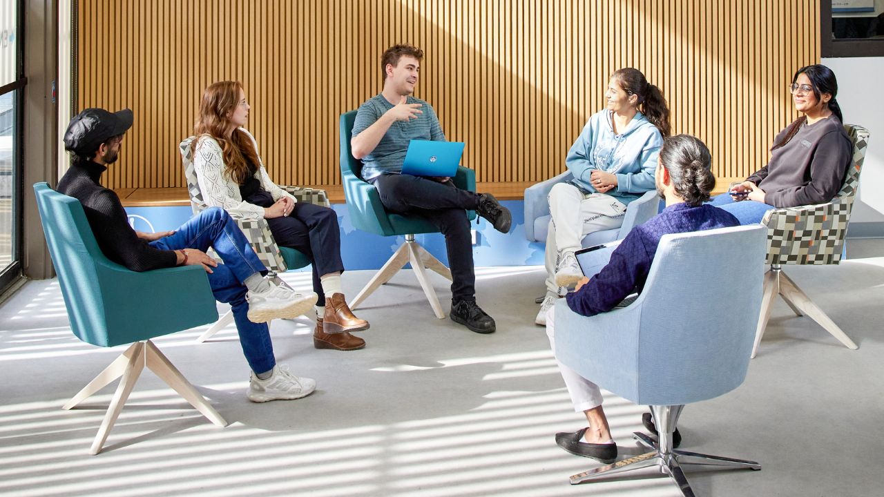 A group of students in conversation in the ALC