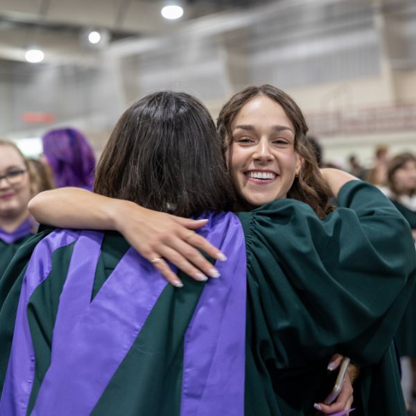 Two students hugging at Convocation