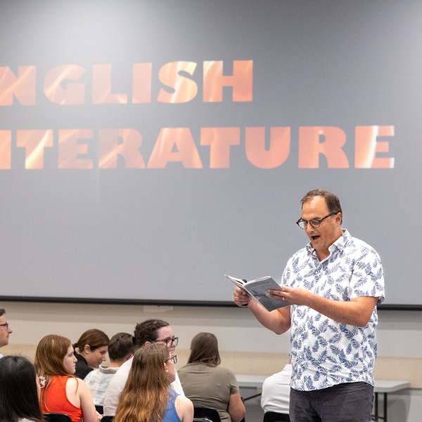 A professor speaking in front of a classroom