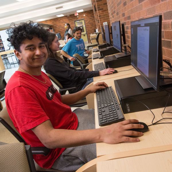 A student using a computer in the library