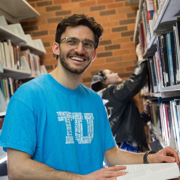 A student smiling in the library