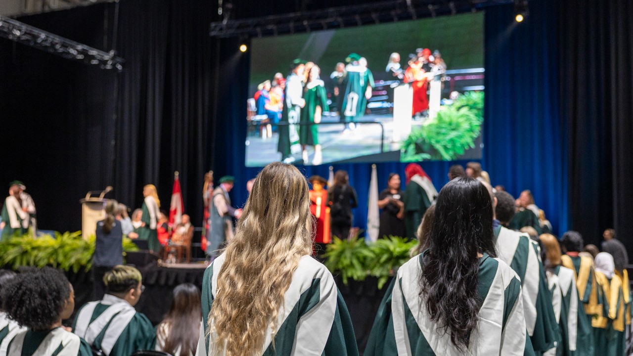 Students lining up to cross the stage at Convocation