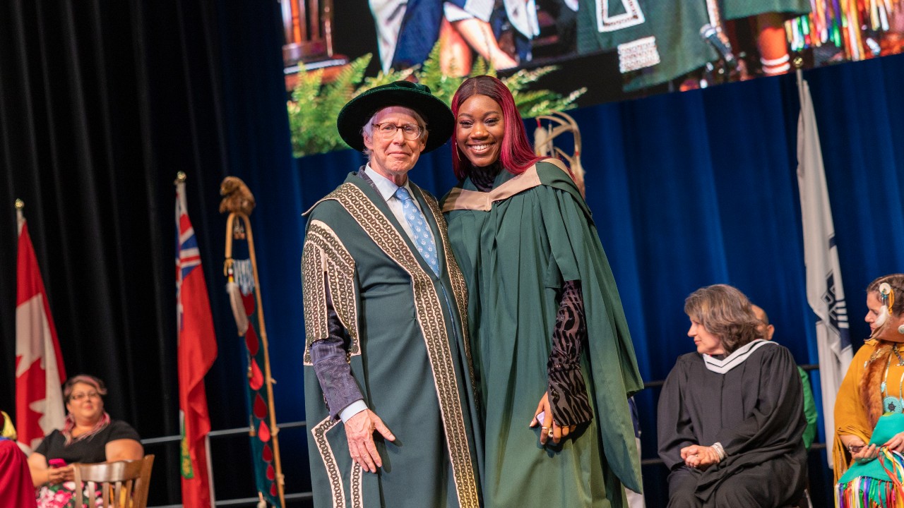 A graduting student with Chancellor Stephen Stohn