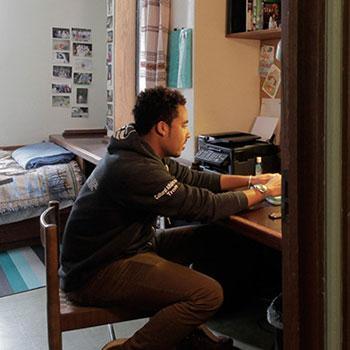 A male student studying in a residence room