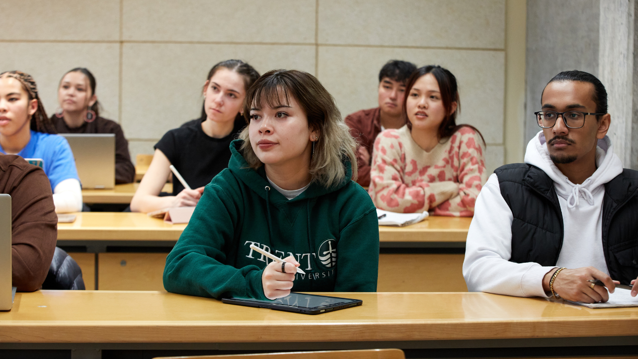 Trent students listening to professor in seminar room.