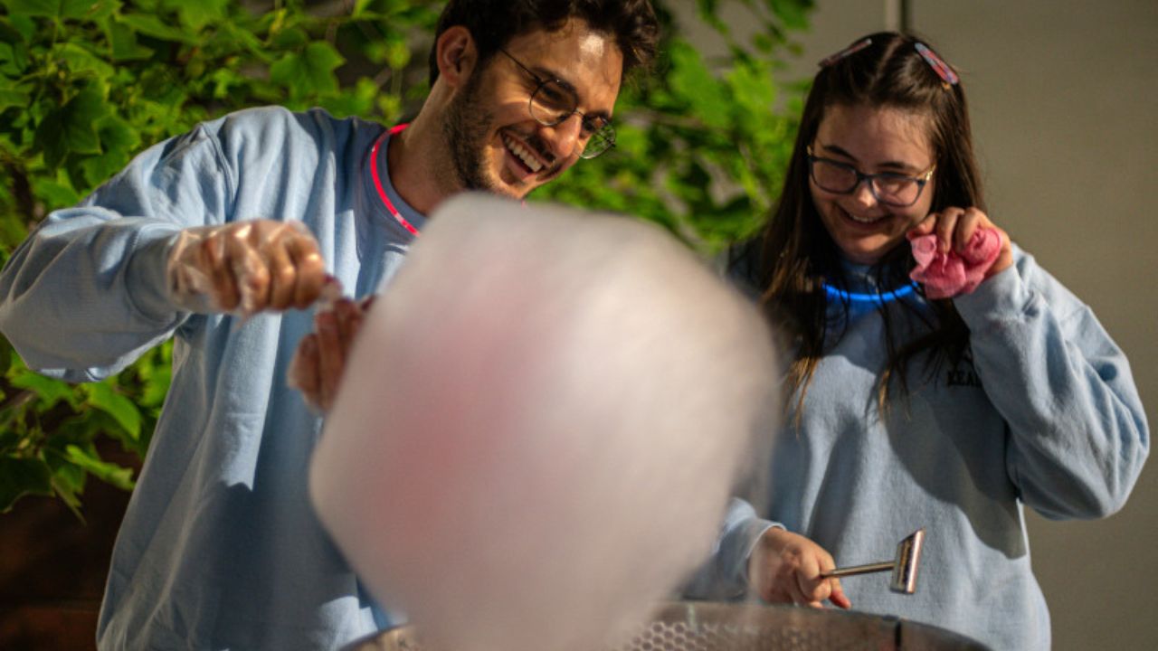 Two students making cotton candy