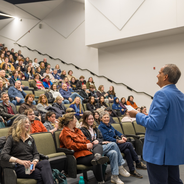 Michael Khan, Provost and Vice President Academic, at Open House, talking to lecture hall of students and their families.