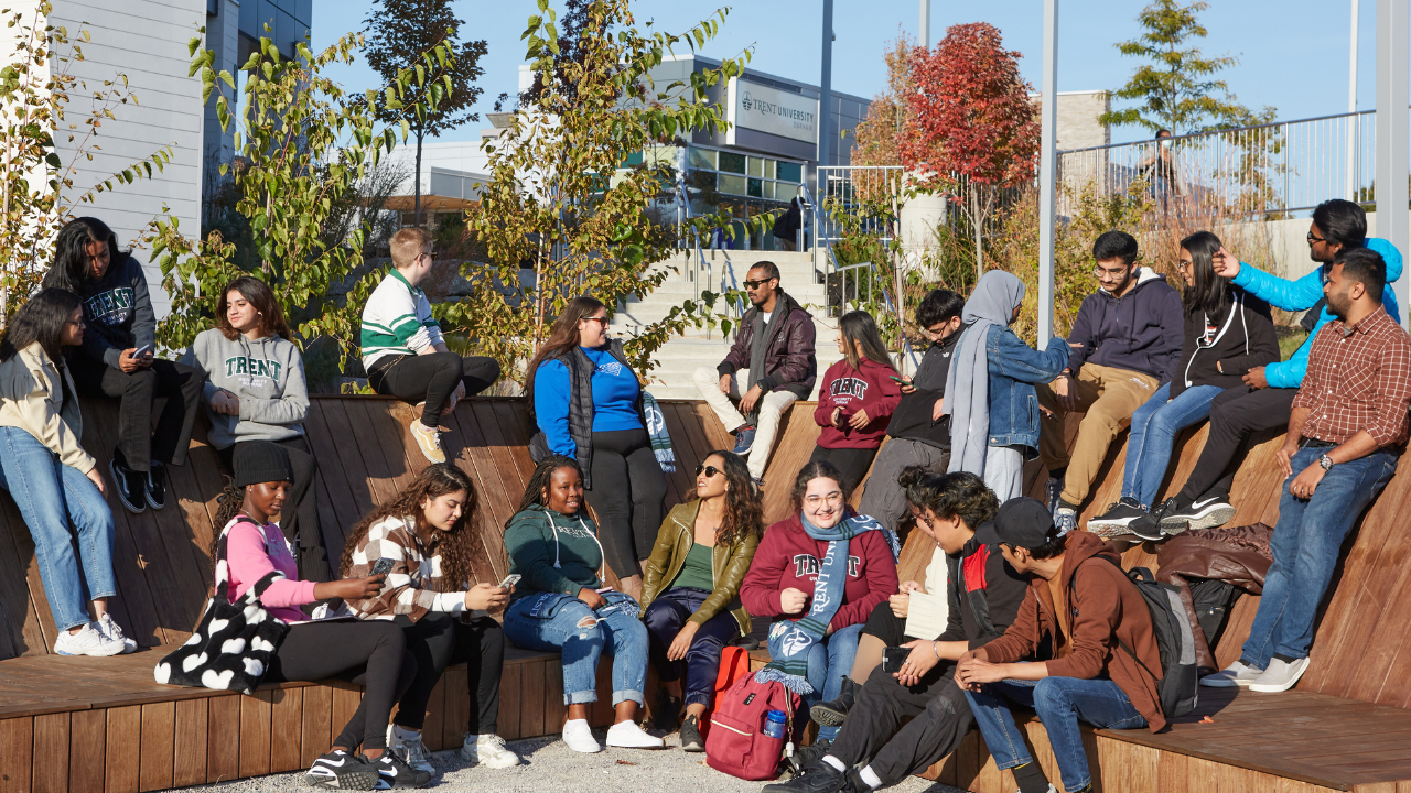 Group of Trent Durham students sitting outside together.