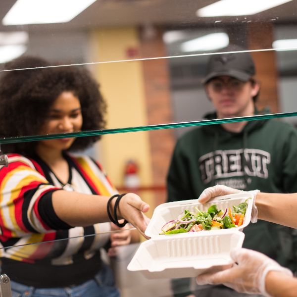 Two students getting food at the cafeteria