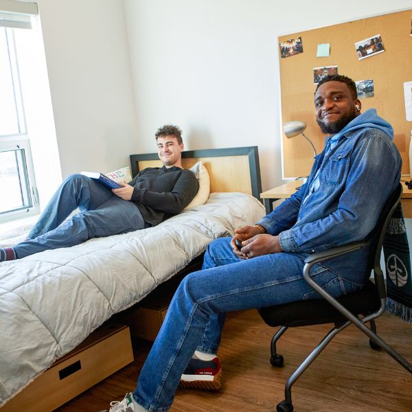 Two students relaxing in a Trent Durham residence room