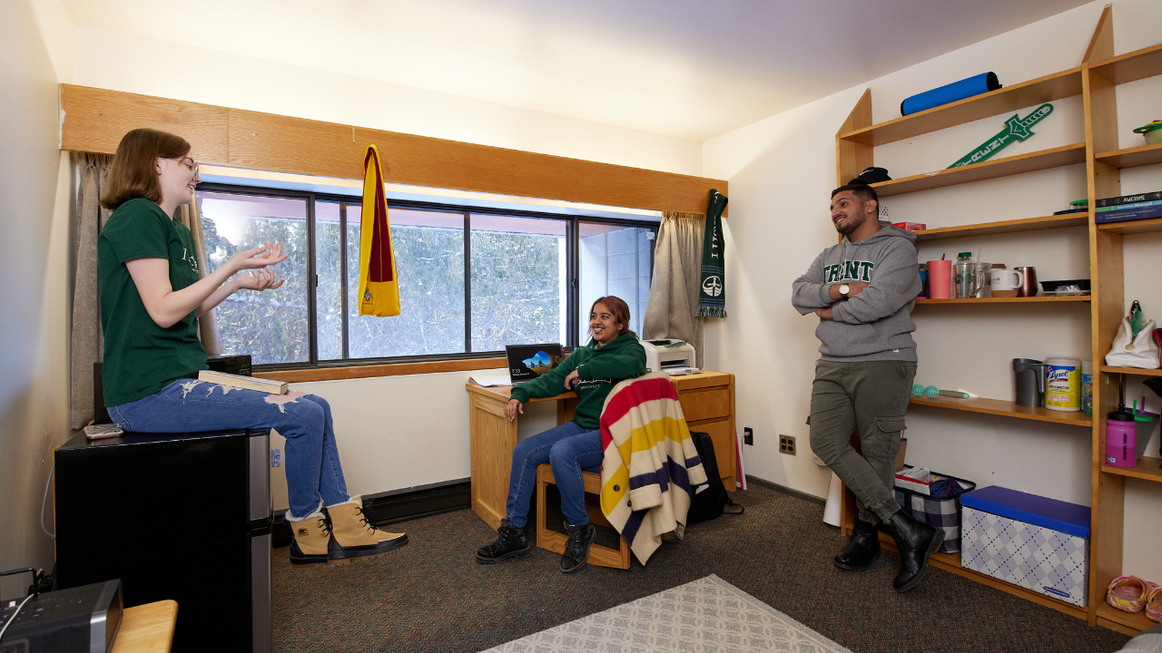 Three students talking a residence room