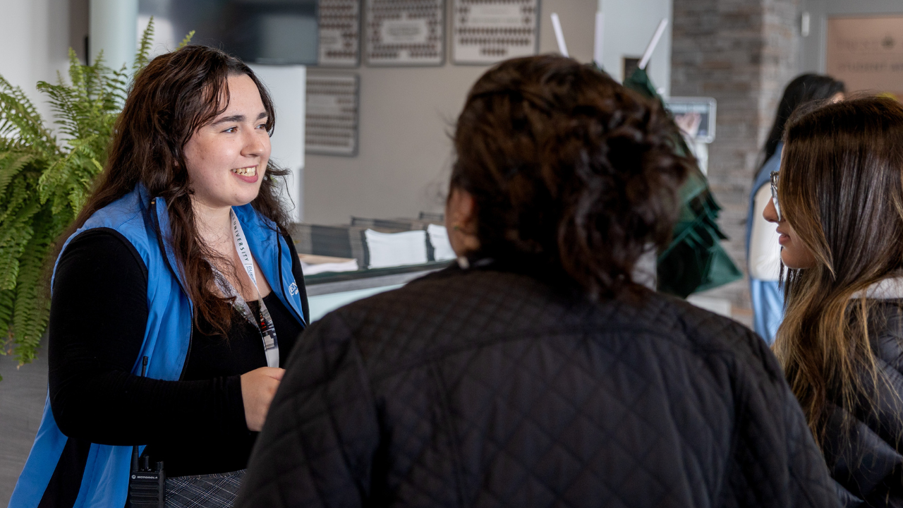 A future student and their parent talking to Trent University Enrolment advisor during Trent Durham GTA open house.