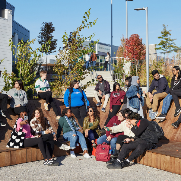 Group of Trent Durham students sitting outside together. 