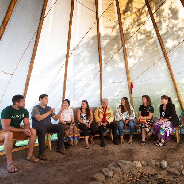 First peoples house of learning staff talking with students.