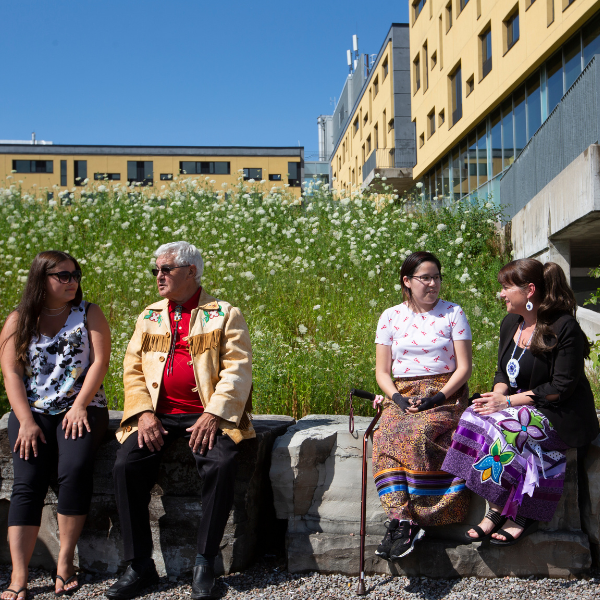 First peoples house of learning staff talking with students.