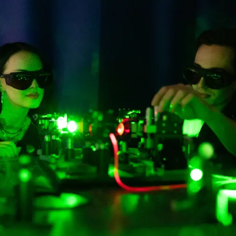 two students working in a laser lab together.