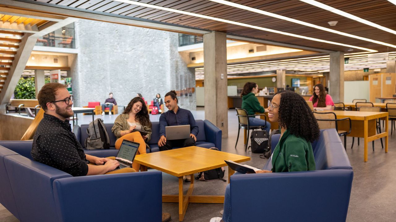 Students working at table in Bata library