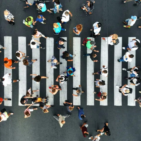 View from above of groups of people walking around a street.