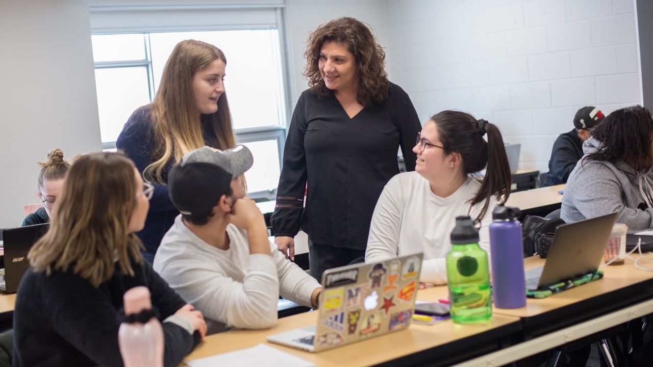 A teacher talking with students