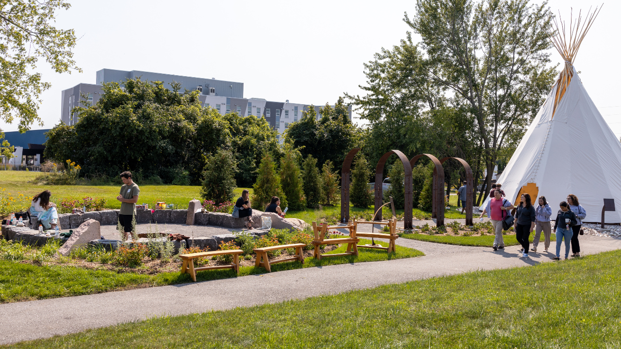 Trent students inside of Durham's traditional area with tipi and medicine garden.