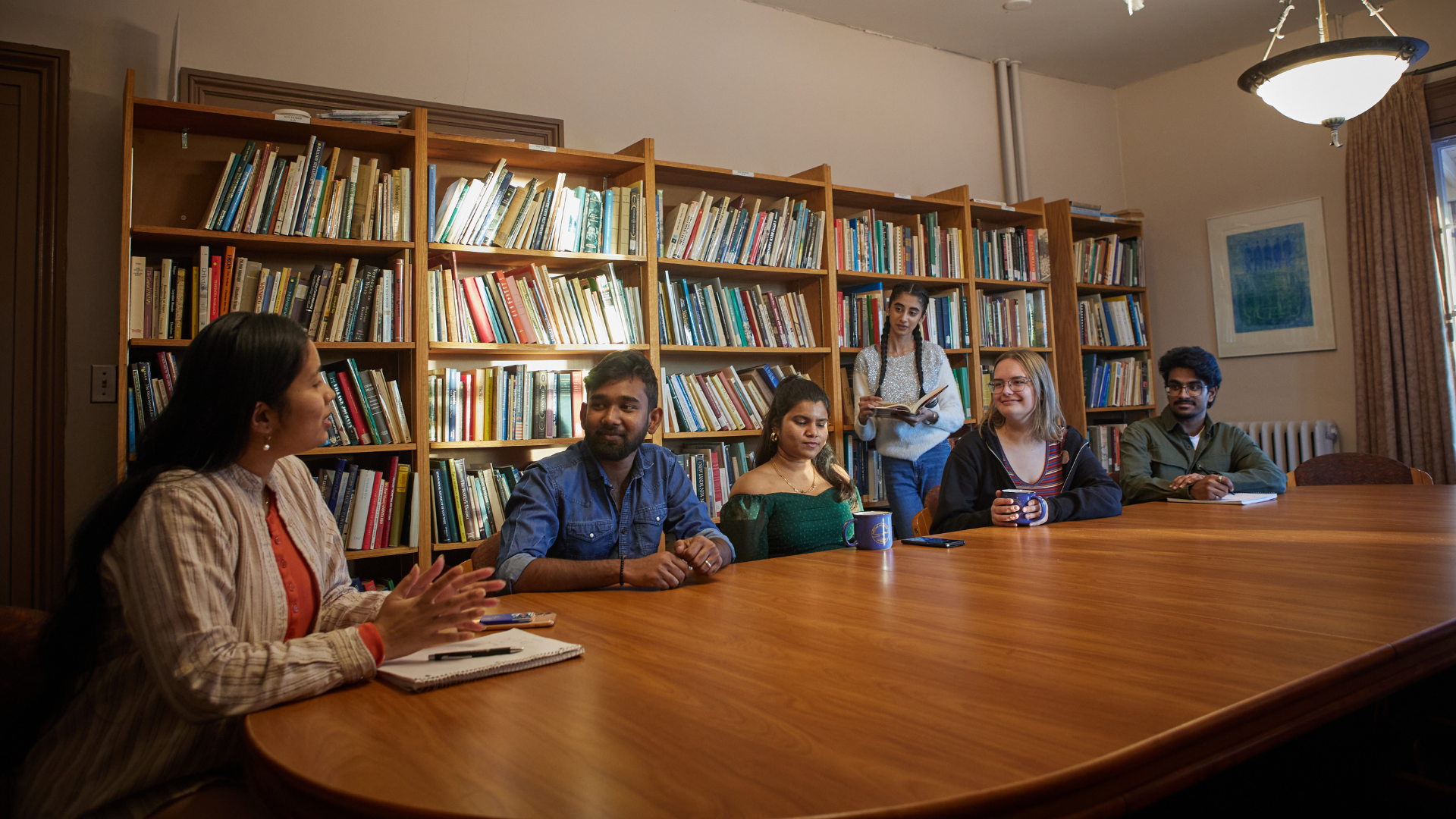 Students teaching in classroom with other students.