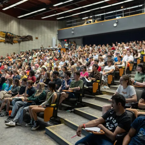 Trent University lecture hall, full of students, listening to professor.