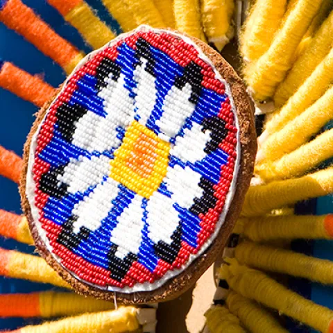 A close up of a handmade dream catcher made of colourful beads