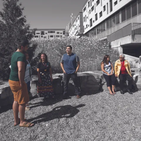 Trent University First Peoples House of Learning students and staff talking outside.