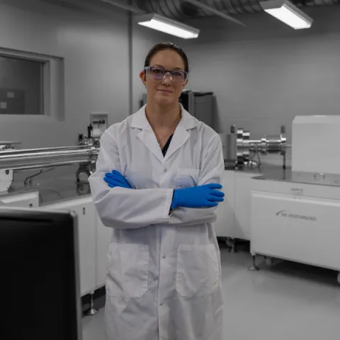 Trent University student, in lab, smiling at the camera.