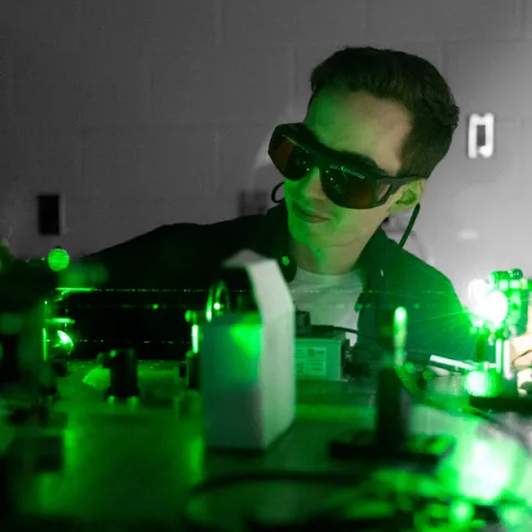 Trent University student using a laser.