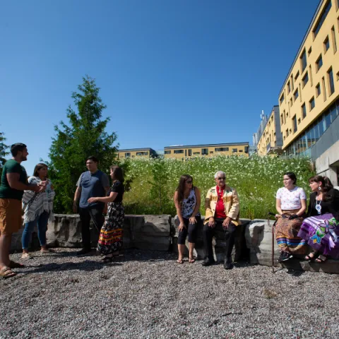 Trent University First Peoples House of Learning students and staff talking outside.