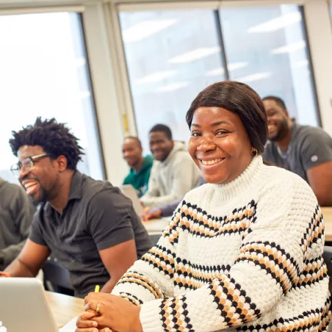 Trent University student, in class at the Advance Learning Centre, smiling at the camera.