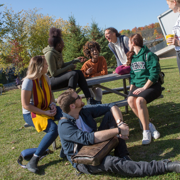 A group of students outside laughing.