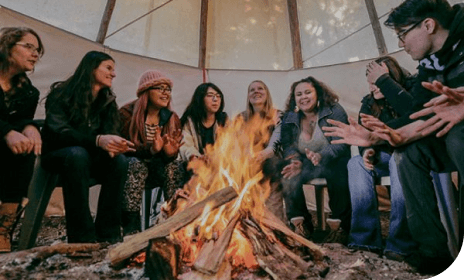 Students around fire in Tipi