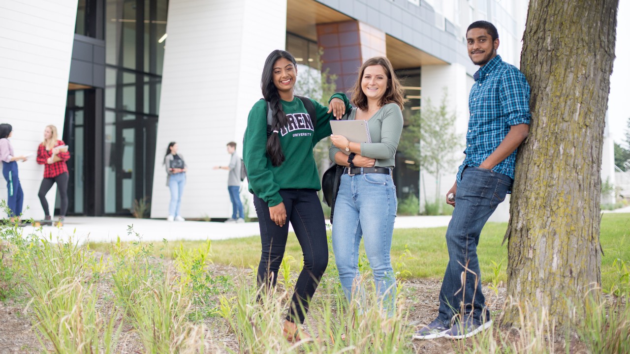 Three students talking on the Durham campus