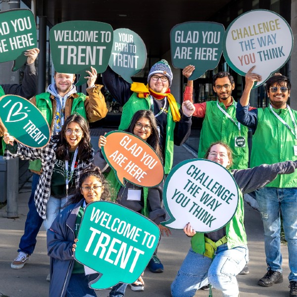 A welcome committee with welcome signs