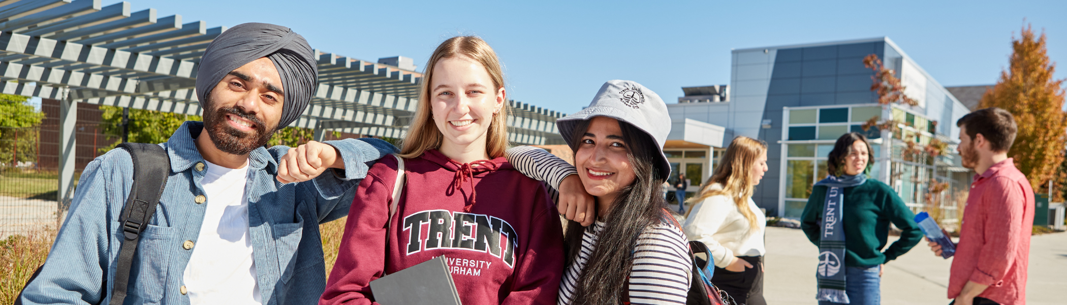 Trent students smiling at camera.