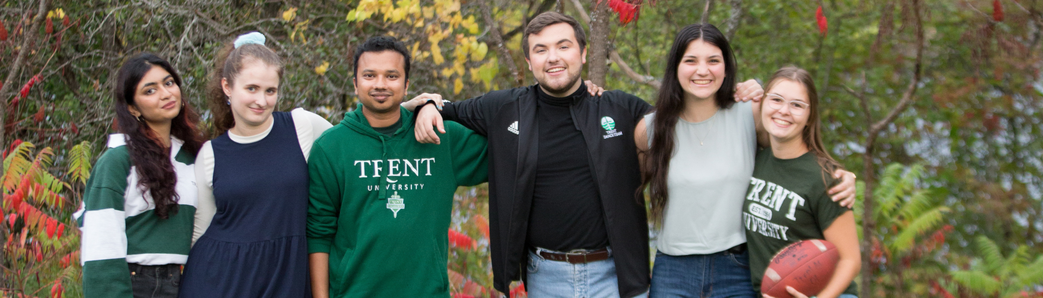 Trent students smiling at camera.