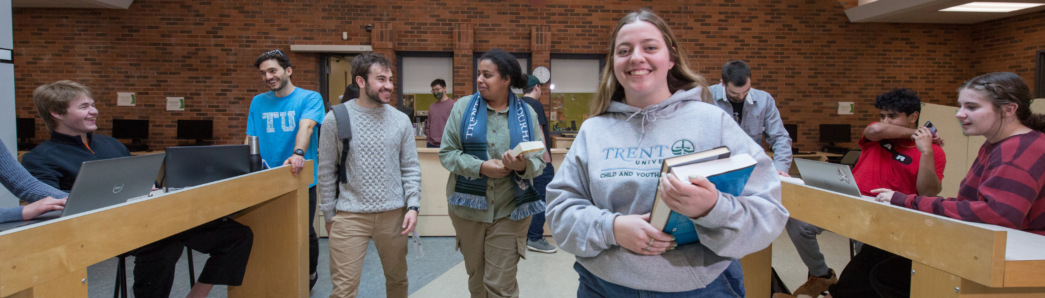 Trent students smiling at camera.