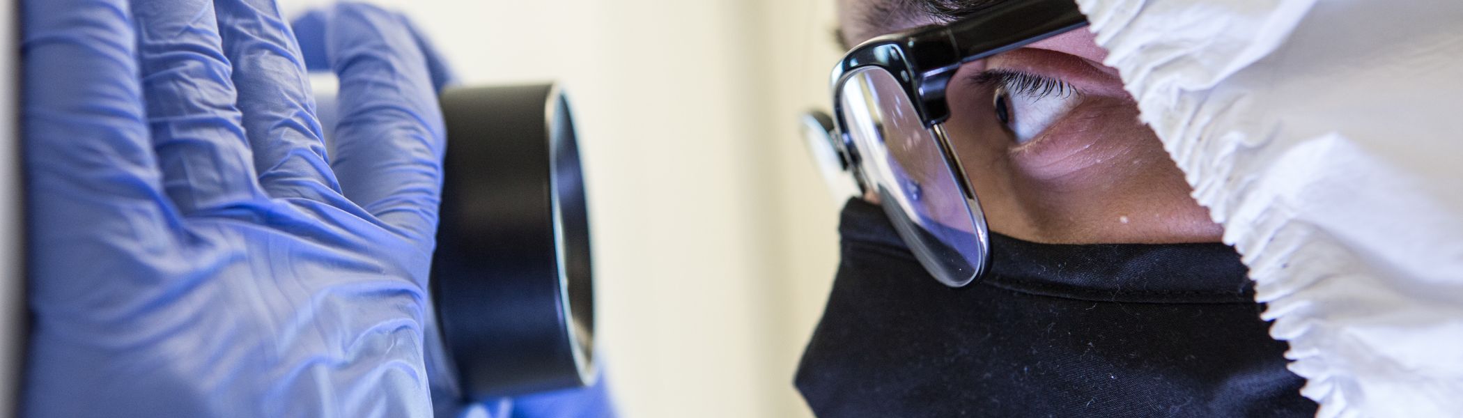 A student looking through a magnifier