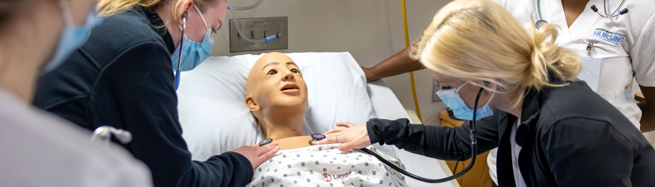 Nursing students working on a patient simulator