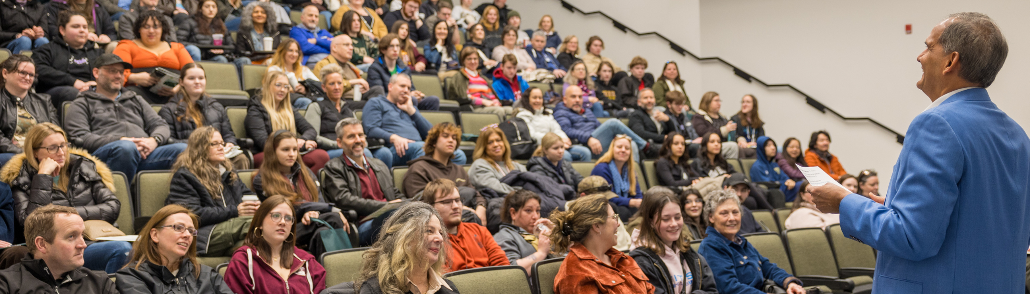 Michael Khan, Provost and Vice President Academic, at Open House, talking to lecture hall of students and their families.